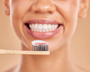 Image showing Woman, teeth and big smile with toothbrush for dental care, hygiene or wellness against a studio background. Closeup of female mouth smiling with tooth paste for healthy or clean oral and gums