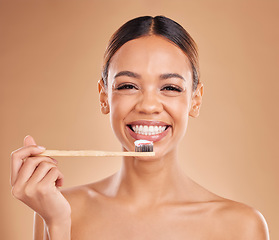 Image showing Portrait, toothpaste or woman brushing teeth with product for healthy oral or dental hygiene in studio. Face, smile beauty or happy girl model cleaning mouth with a natural bamboo wooden toothbrush