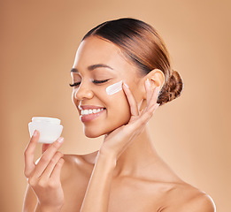 Image showing Woman, skincare cream jar and studio for beauty, wellness or self care for face health by background. Girl, model and happy for cosmetic skin product for natural glow, collagen or dermatology benefit