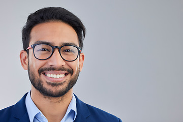 Image showing Portrait, happy and excited businessman in studio with glasses, smile and confident on grey background space. Face, isolated and young mexican entrepreneur pose empowered, professional and handsome