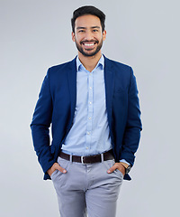 Image showing Business man, smile and fashion portrait in studio as corporate worker or CEO while happy. Face of asian entrepreneur person on isolated white background with pride, success and hands in pocket