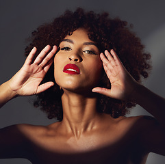 Image showing Black woman, red lipstick and spotlight with beauty and makeup in portrait, hands frame face on studio background. Cosmetics, creative and aesthetic with beautiful female, cosmetology and art deco