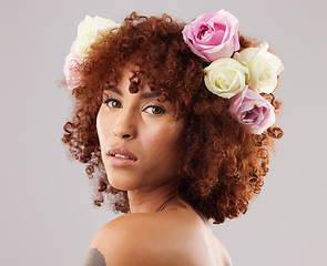 Image showing Portrait, beauty and flowers with a model black woman in studio on a gray background for natural skincare. Wellness, luxury and face with an attractive young female wearing a flower crown or wreath