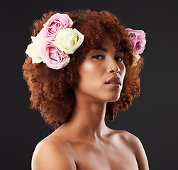 Image showing Face, skincare and flowers with a model woman in studio on a dark background for natural beauty. Wellness, luxury and portrait with an attractive young female wearing a flower crown or wreath