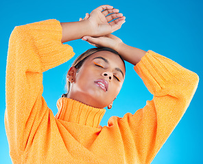 Image showing Woman, makeup and fashion aesthetic of a young female with cosmetics in a studio. Posing, gen z and stylish person with youth and colorful eyeliner with isolated and blue background feeling cool