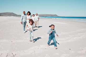 Image showing Family, beach and happy kids running in sand, playful and having fun while bonding outdoors. Face, children and parents with grandparents on summer vacation at sea on ocean trip in South Africa