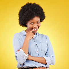 Image showing Happy, flirting and portrait of a black woman in a studio with confidence, love and romance face. Happiness, smirk and African female model biting her finger for a sexy gesture by a yellow background