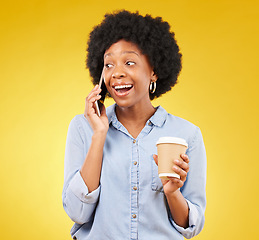 Image showing Phone call, happy and black woman with coffee in studio, smile and listening on yellow background. Smartphone, conversation and girl with tea surprised, joke and humor while enjoying speaking online