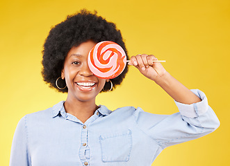 Image showing Cover, candy and lollipop with black woman in studio for colorful, cheerful and positive. Young, happiness and dessert with female isolated on yellow background for treats, food and confectionary