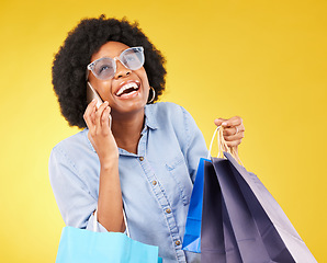 Image showing Shopping bag, phone call communication or black woman with sales product, discount fashion deal or mall store present. Talking, designer gift or chic happy customer chat isolated on yellow background