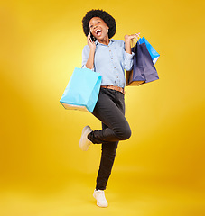 Image showing Shopping bag, excited phone call and portrait black woman with sales product, discount fashion deal or mall store present. Talking, designer gift and happy customer chat isolated on yellow background