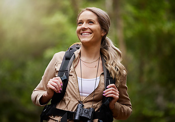 Image showing Hiking, smile and woods with a woman outdoor, walking in nature or the wilderness for adventure. Freedom, location and forest with an attractive young female hiker taking a walk in a natural park