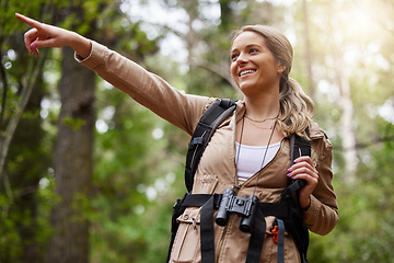 Image showing Hiking, pointing or girl in nature, forest or wilderness for a happy trekking adventure with freedom. Excited woman or hiker walking in a natural park or woods for exercise or holiday vacation view