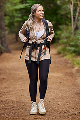 Image showing Hiking, idea and forest with a woman outdoor, walking in nature or the wilderness for adventure. Freedom, location and woods with an attractive young female hiker taking a walk in a natural park