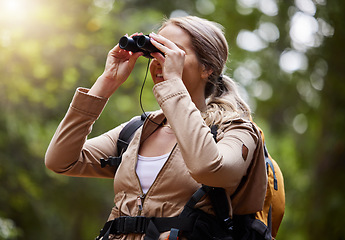 Image showing Binoculars, forest explore and woman on travel journey, jungle adventure or hiking for carbon footprint holiday. Happy hiker person trekking in tropical woods or eco green environment search or watch