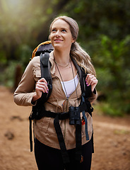 Image showing Hiking, smile and forest with a woman outdoor, walking in nature or the wilderness for adventure. Freedom, thinking and woods with an attractive young female hiker taking a walk in a natural park