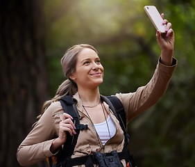 Image showing Hiking, selfie or happy woman in nature, forest or wilderness live streaming trekking adventure. Pictures, social media vlogger or hiker walking in park or woods for exercise or wellness on holiday