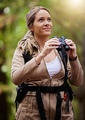 Image showing Binoculars, nature and happy woman hiking for travel journey, jungle adventure and forest explore with backpack gear. Sports hiker or person birdwatching and trekking in eco, green or tropical woods