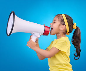 Image showing Communication, shout and child with megaphone for news, opinion and announcement on blue background. Talking, speaking mockup and young girl with loudspeaker for voice, scream and attention in studio