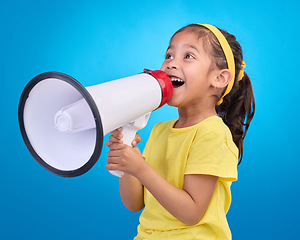 Image showing Communication, speech and child with megaphone for news, opinion and announcement on blue background. Talking, speaking mockup and young girl with microphone for voice, scream and attention in studio