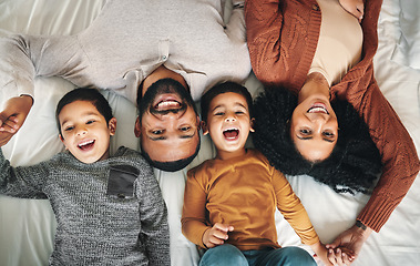 Image showing Laughing, family and top view portrait on bed in bedroom, bonding and care in home. Love, smile and happy mother, comic father and funny children playing, having fun and enjoying joke time together.