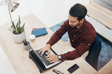 Image showing Business man typing, laptop and concentrate on work, tech support with keyboard and productivity in office. Information technology, communication and male writing email or software update top view