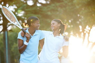 Image showing Tennis, team and happiness with women outdoor, sun and lens flare, sports and fitness, collaboration and hug. Exercise, bonding and female laugh, athlete and workout with partnership and racket