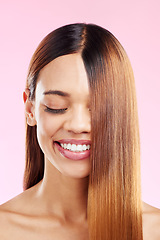 Image showing Woman, beauty smile and hair in studio for salon, hairdresser or shine shampoo or treatment. Skincare and makeup glow or hairstyle of aesthetic model on a pink background for self care cosmetics