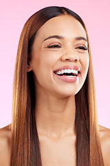 Image showing Beauty cosmetics, hair and woman with a smile in studio for salon, hairdresser or shine. Skincare glow or hairstyle of aesthetic model person on a pink background laughing with self care skin bliss