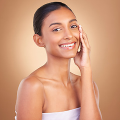 Image showing Makeup, beauty and portrait of Indian woman for skincare, wellness and facial treatment in studio. Dermatology, luxury spa and happy girl touching face for confidence with makeup, cosmetics and smile