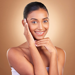 Image showing Beauty, skincare and touch with portrait of indian woman in studio for happy, spa and facial. Cosmetics, self care and glow with model on brown background for satisfaction, makeup and confidence