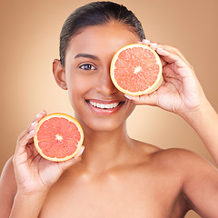 Image showing Skincare, woman portrait and grapefruit for health, wellness and beauty of a young model with happiness. Studio, smile and healthy fruit with vitamin c and fruits nutrition for facial and dermatology