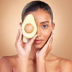 Image showing Woman, beauty and face with avocado and natural skincare in portrait, facial and makeup on studio background. Vegan, cosmetic care and product from nature, organic and female with hands and glow