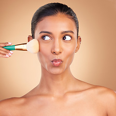 Image showing Makeup, beauty and brush with indian woman in studio for foundation, blush and self care. Glow, cosmetics and facial with female model isolated on brown background for shine, clean and confidence