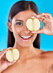 Image showing Skincare, smile and portrait of Indian woman with apple slices and facial detox with fruit on blue background. Health, wellness and face of model with organic luxurycleaning and grooming cosmetics.