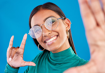 Image showing Woman, fashion and selfie portrait with rock on hand for gen z attitude on blue background with glasses. Face of happy model person in studio with smile or cool sign emoji for beauty and motivation