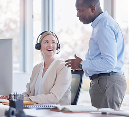 Image showing Manager, call center woman and talking for support, advice or help with telemarketing sales. Black man mentor and consultant or agent for CRM, customer service or contact us consultation at desk