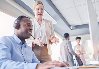 Image showing Call center, black man and manager talking at computer desk for support, advice or help with telemarketing. Consultant or agent with mentor woman for CRM, customer service or contact us communication