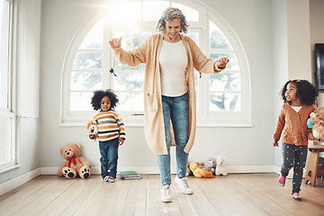 Image showing Hopscotch, grandmother and children play in home having fun, enjoy games and balance together in bedroom. Happy family, entertainment and grandma with kids for jumping, playing and numbers activity