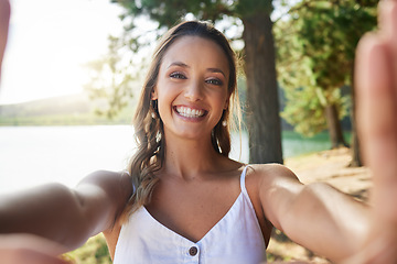 Image showing Nature, happy and woman taking a selfie in the forest while on outdoor adventure alone on a weekend trip. Happiness, smile and portrait of female taking picture in woods on travel holiday or vacation