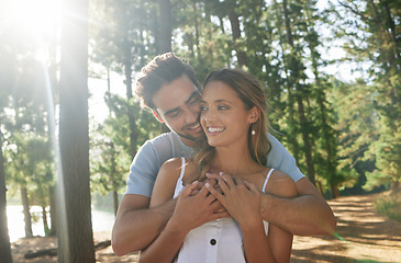 Image showing Hug, happy and an affectionate couple in nature for romance, a date and walking in the morning. Smile, embrace and a man and woman with affection, hugging and content together in the woods or forest