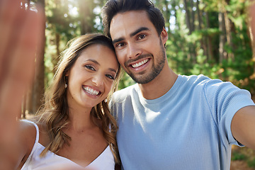 Image showing Selfie, happy and portrait of a couple in nature for bonding, quality time and a memory. Smile, looking and a young man and woman taking a photo while on a date in the forest or woods together