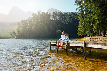Image showing Love, relax and pier with couple at lake for bonding, romance and affectionate date. Nature, travel and holiday with man and woman cuddling on boardwalk in countryside for happy, summer and vacation