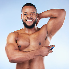 Image showing Deodorant, portrait and black man with smile in studio for beauty, grooming and body hygiene on blue background. Skincare, health and male spraying aerosol, fragrance and scent product for underarm