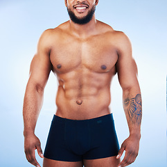 Image showing Black man in underwear, fitness and body with abs, healthy and active, muscle and strong on blue backgroun. Shirtless male, exercise and bodybuilder, bare abdomen and workout with smile in studio