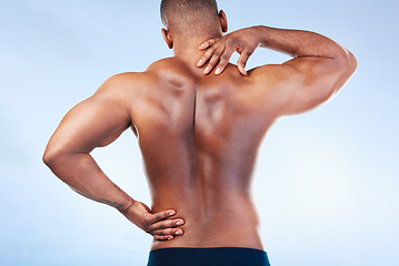 Image showing Black man, neck pain and back injury with fitness and health, medical problem and aching body in studio. Emergency, muscle tension and male athlete with joint ache from workout on blue background