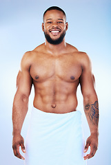 Image showing African man, shower and towel in studio portrait with smile, wellness and start to morning by blue background. Young guy, cleaning body and skincare for happiness, health and self care by backdrop