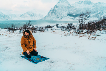 Image showing A Muslim traveling through arctic cold regions while performing the Muslim prayer namaz during breaks