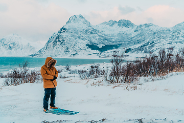 Image showing A Muslim traveling through arctic cold regions while performing the Muslim prayer namaz during breaks