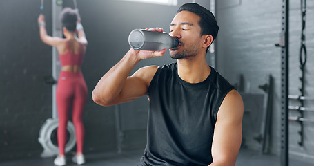 Image showing Man, tired and drinking water in gym workout, training and exercise break for energy recovery and muscle rest. Personal trainer, fitness coach and drink for wellness, sports health and weight loss